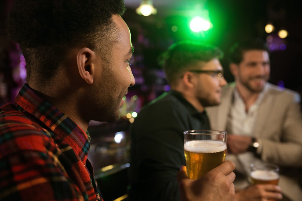 Man having beer with his friends in a pub